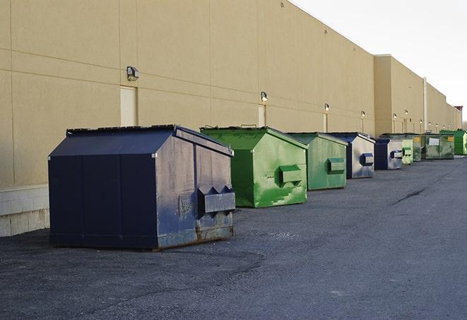 construction workers loading debris into dumpsters in Bear Valley Springs, CA